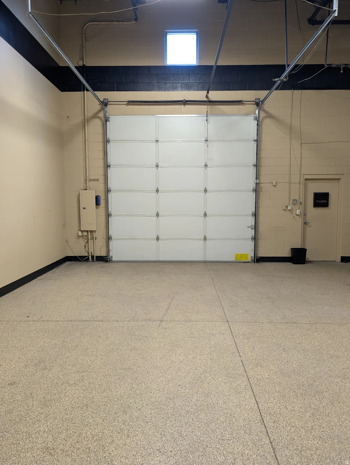 White roll-up garage door with overhead track system