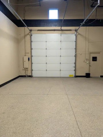 White roll-up garage door with overhead track system