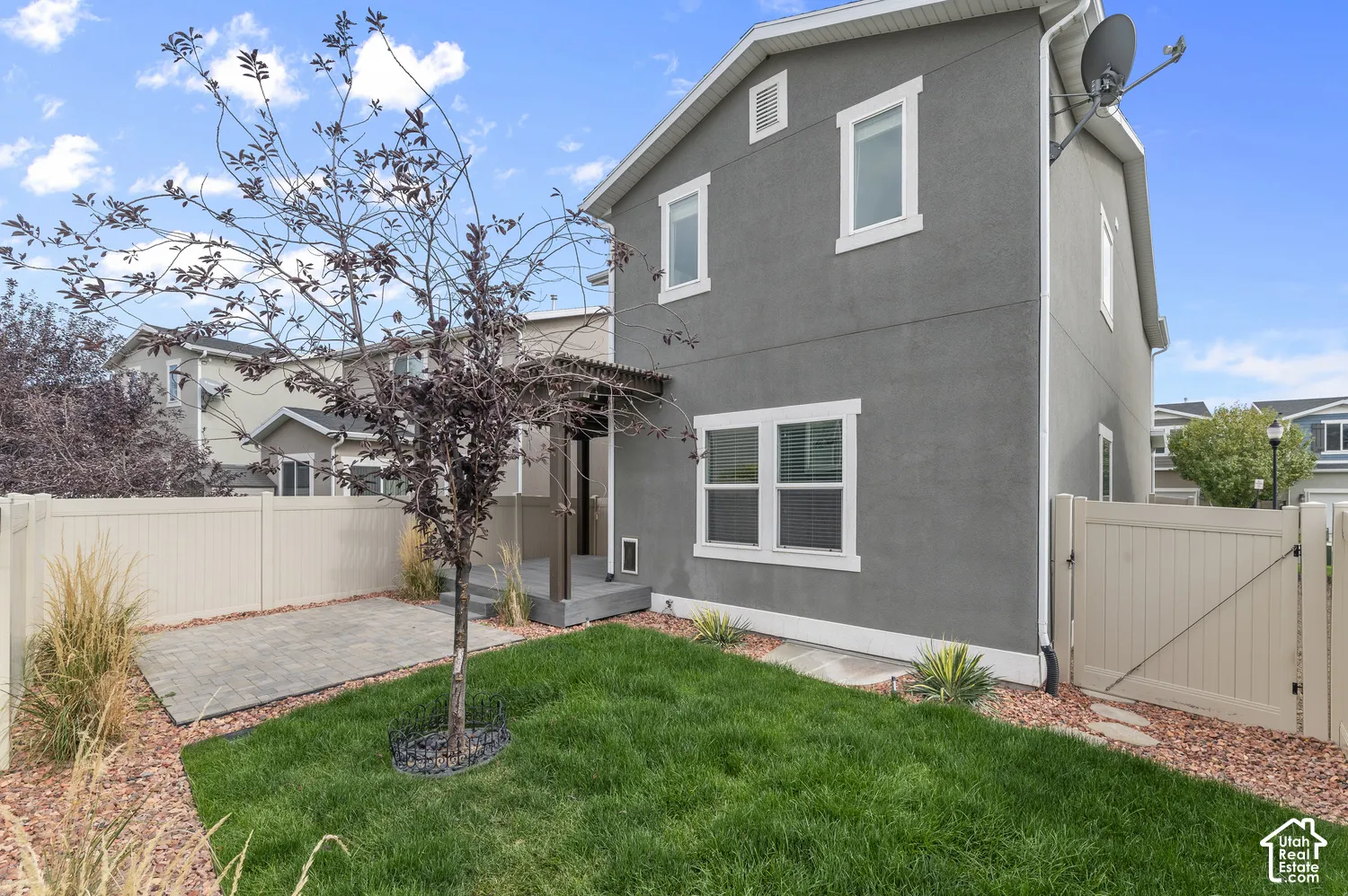 Stucco exterior with white trim windows and a covered entry