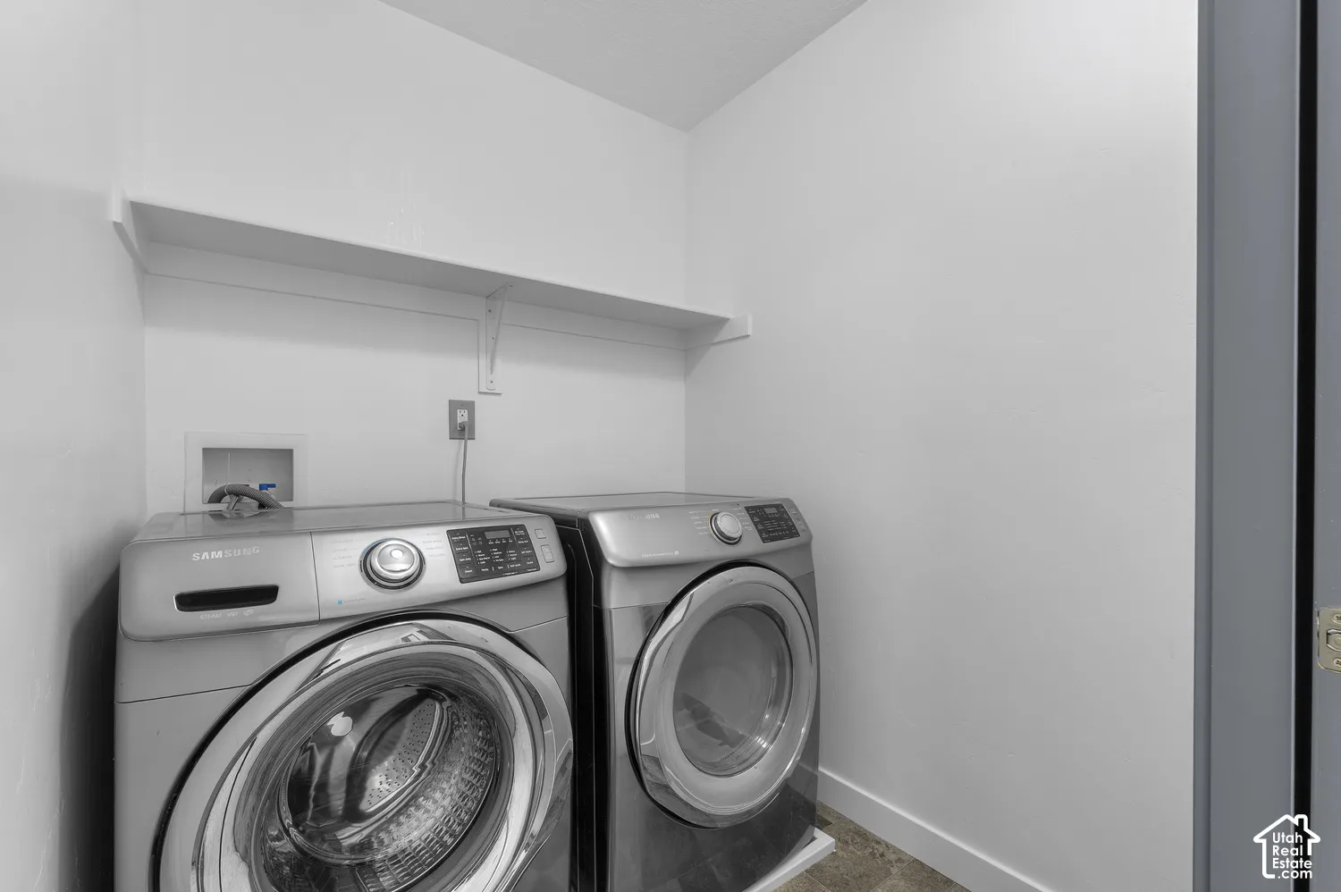 Laundry area with an overhead storage shelf and durable flooring