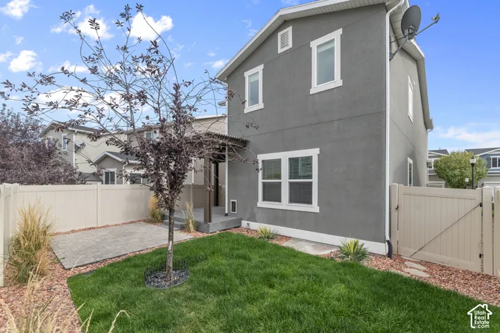 Stucco exterior with white trim windows and a covered entry