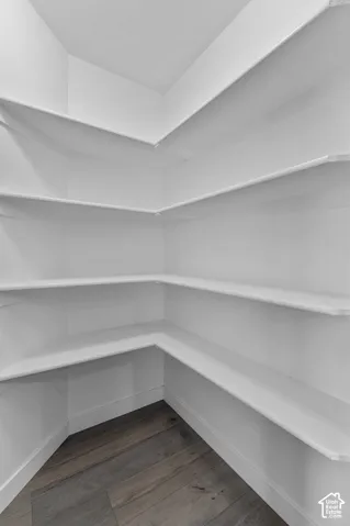 Built-in shelving, white finish, wood-finish flooring, corner configuration, multiple tiers