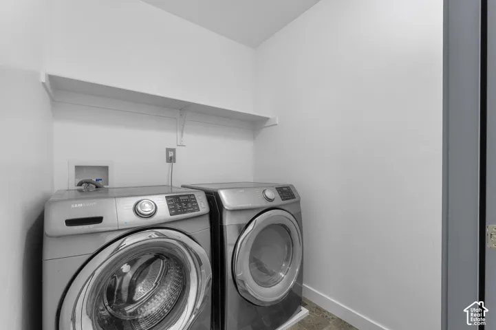 Laundry area with an overhead storage shelf and durable flooring