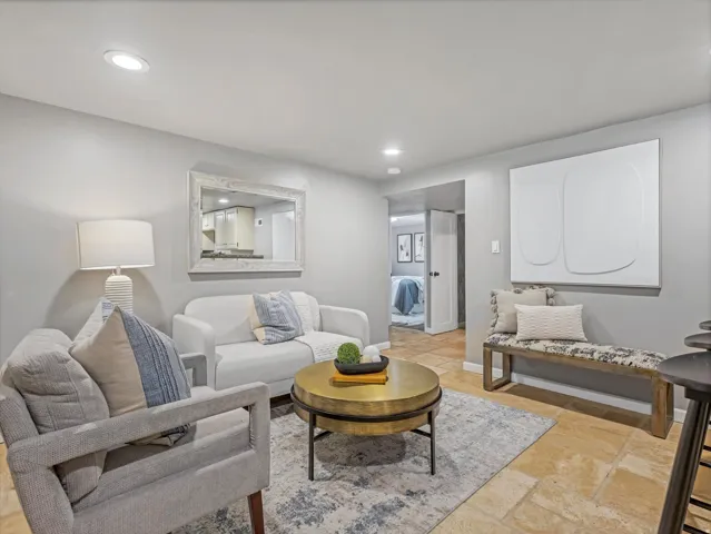 Recessed ceiling lighting, light-toned wall finishes, and tile flooring