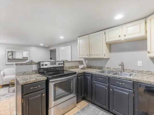 Kitchen featuring a stainless steel electric range, double basin sink, granite-style countertops, and recessed lighting