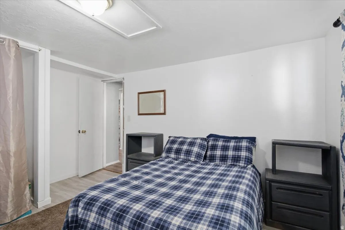 White walls complement the light-colored wood-finish flooring