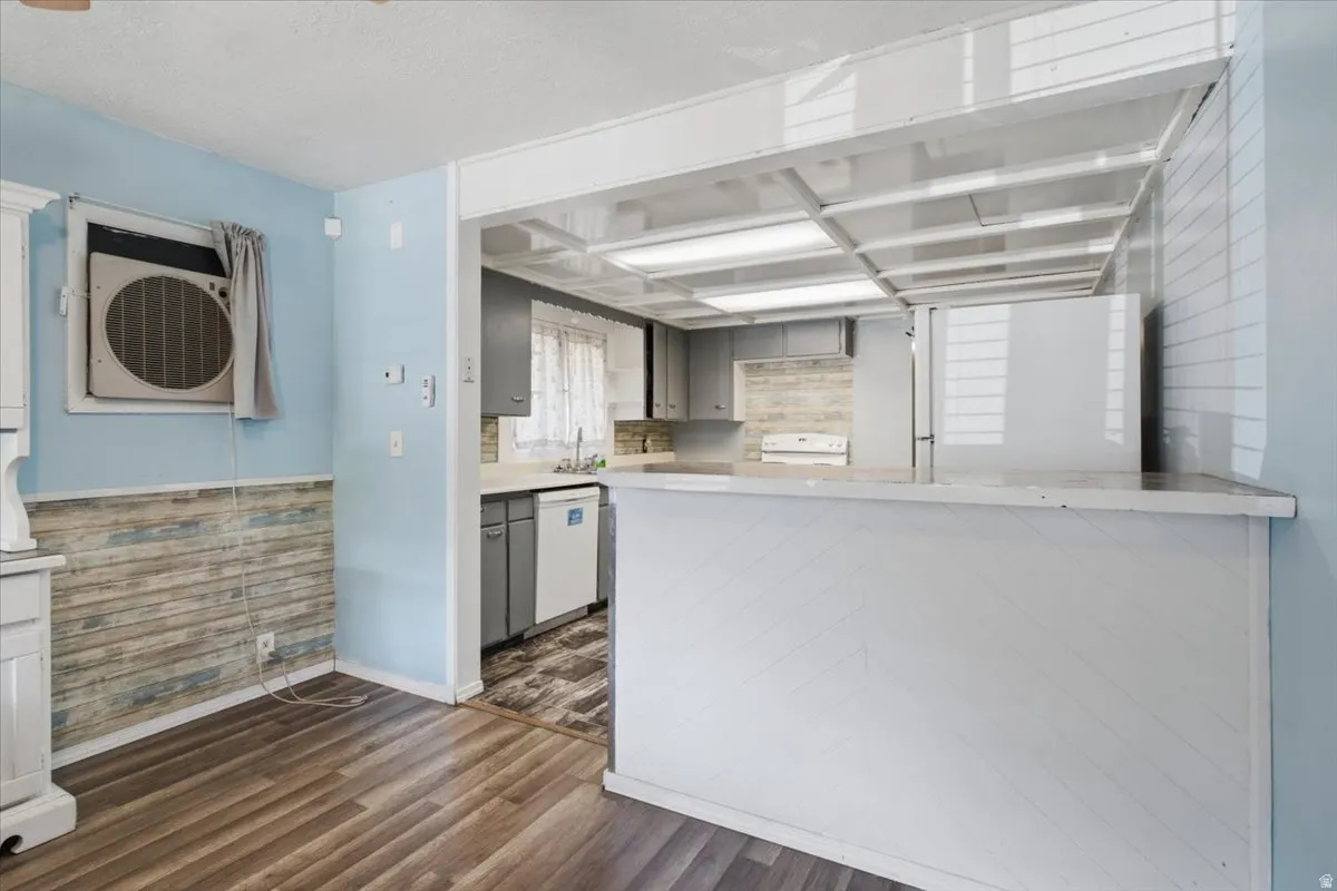 Kitchen pass-through featuring an extended countertop and integrated lighting