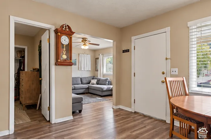 Wood-finish flooring throughout, light-toned wall paint, and white trim work