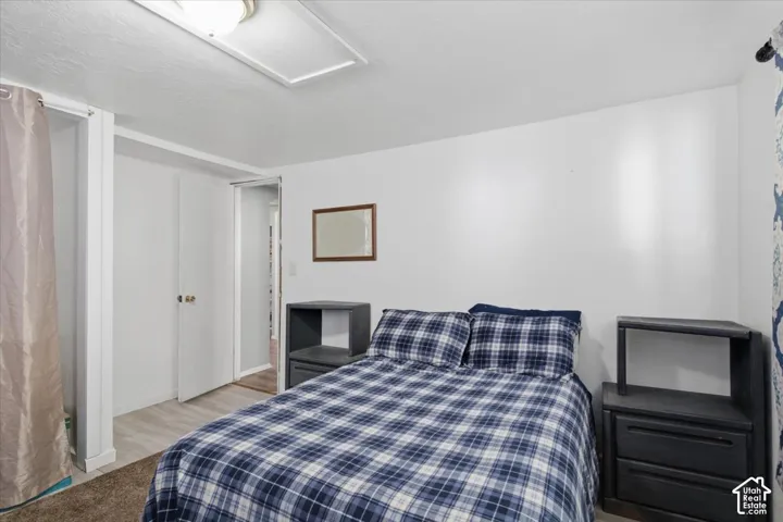 White walls complement the light-colored wood-finish flooring