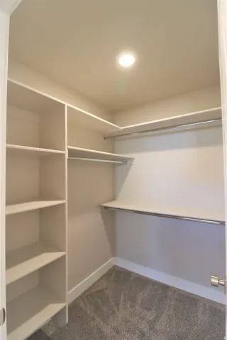 Previous build home - colors and selections may vary. Built-in shelving, hanging rods, recessed ceiling lighting, and carpet flooring