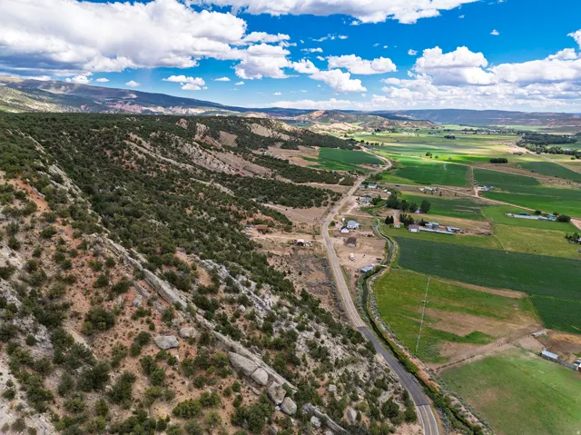 Expansive natural landscape featuring rolling hills and green fields