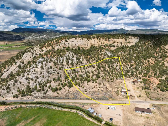 Expansive land parcel with surrounding rugged terrain and distant mountains