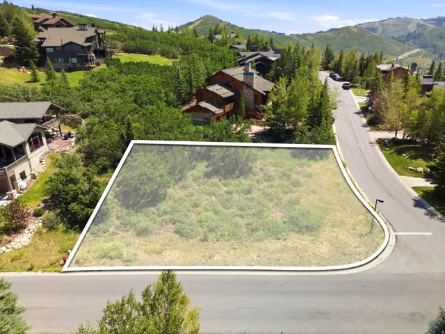 Vacant land parcel with a paved street frontage and established curb