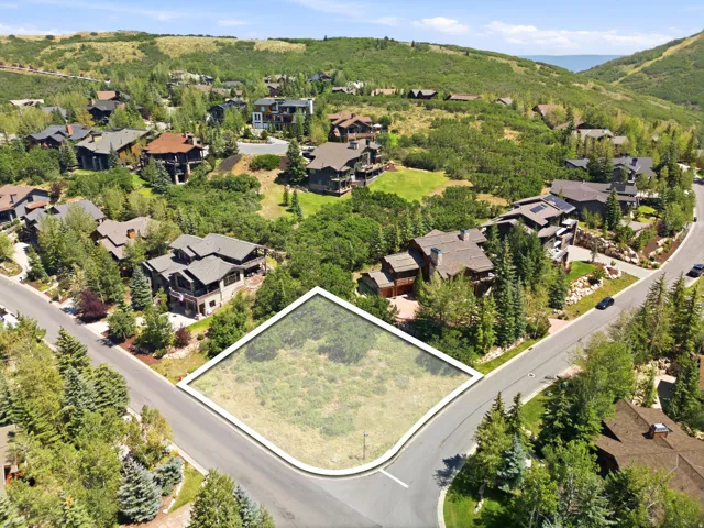 Corner lot featuring a natural landscape and paved road access