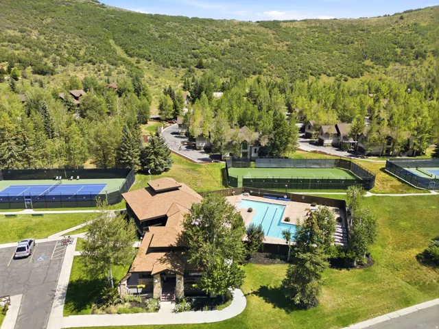 Community amenities featuring a swimming pool, multiple tennis courts, and a multi-sport court