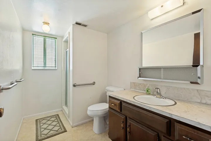 3/4 bathroom in basement with walk in shower.