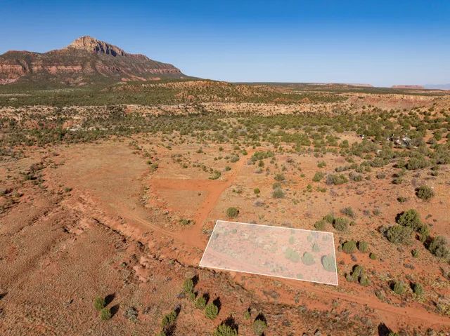 Parcel boundaries outlined — red mesa beyond