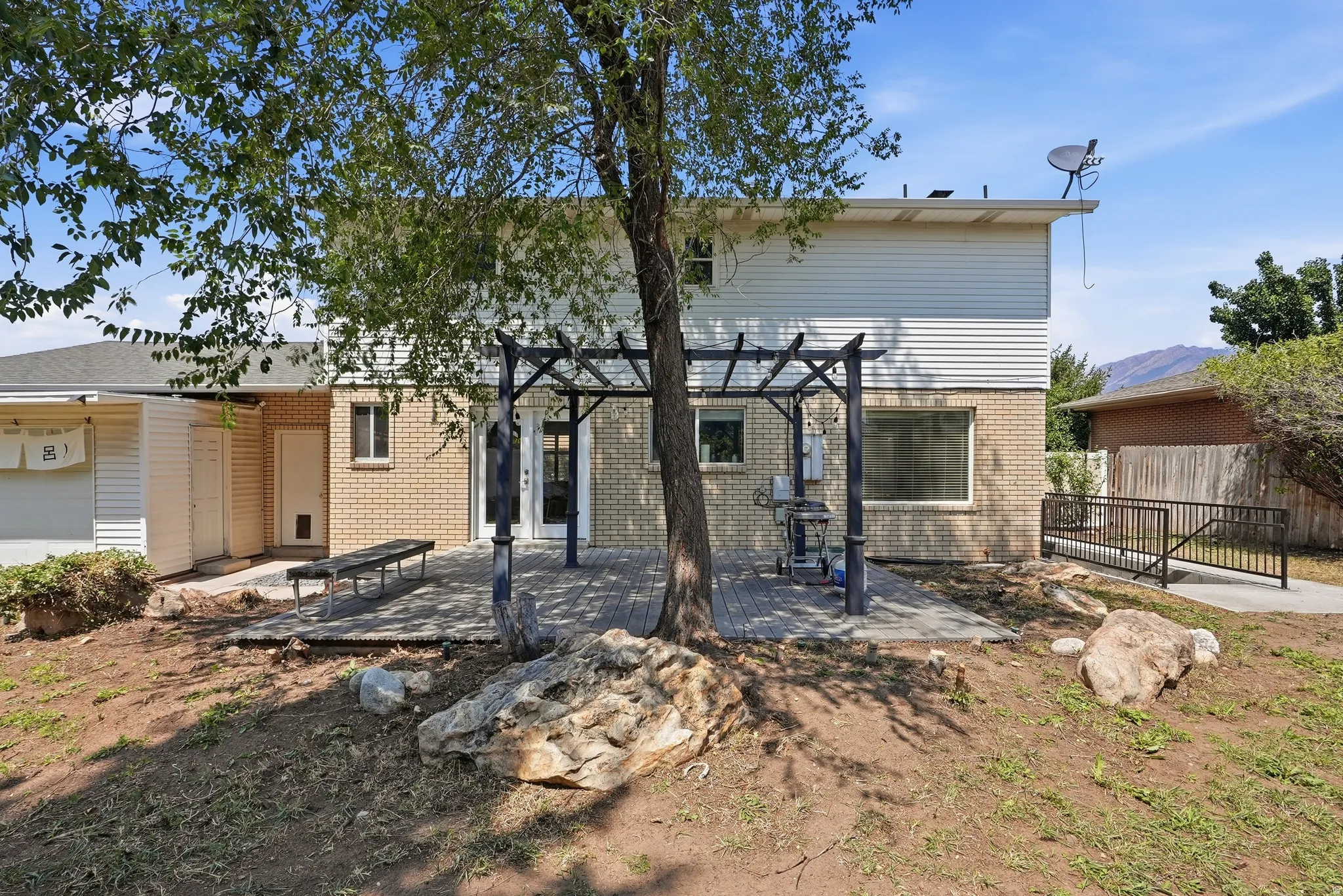 Expansive concrete patio with a pergola