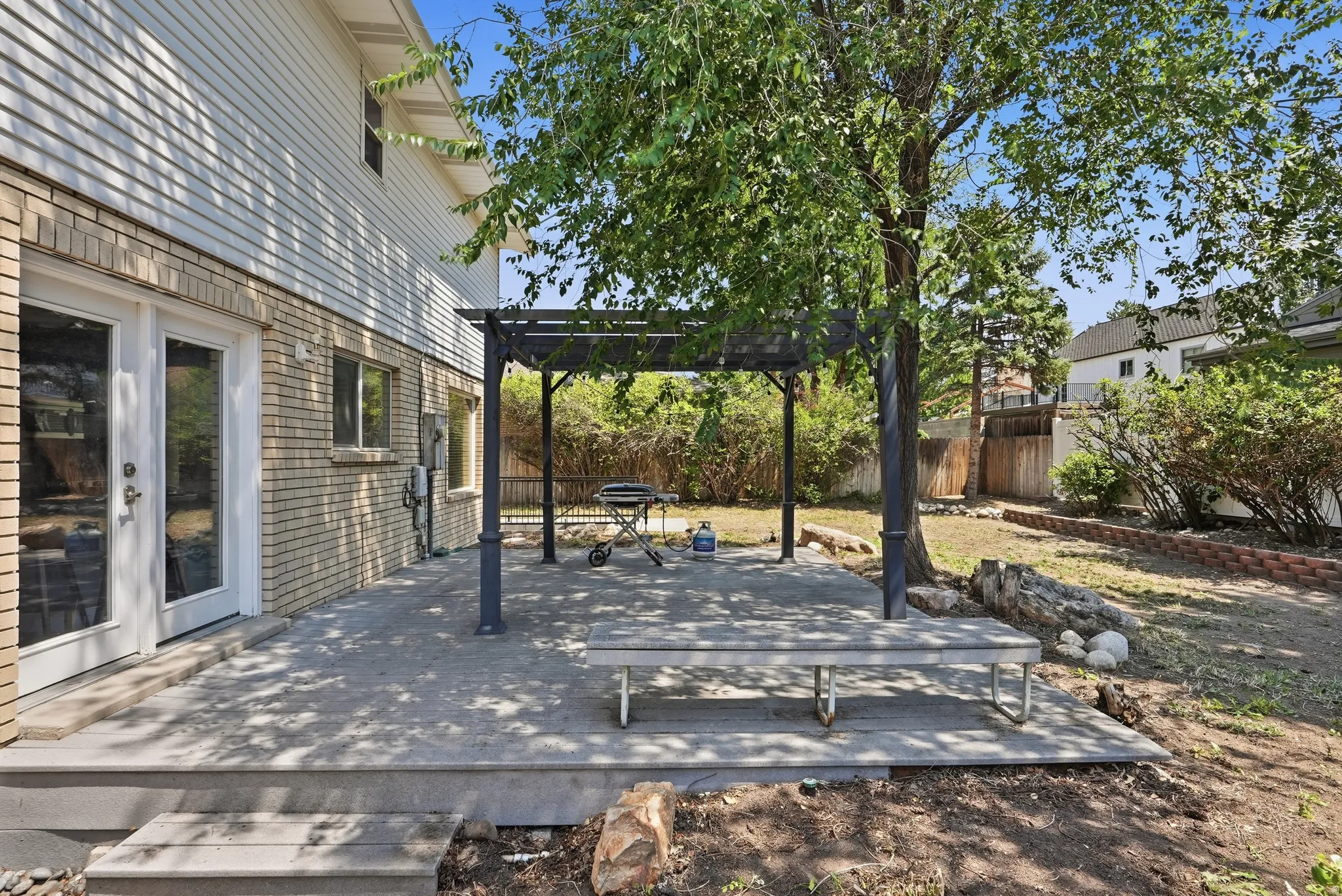 Expansive concrete patio with a pergola