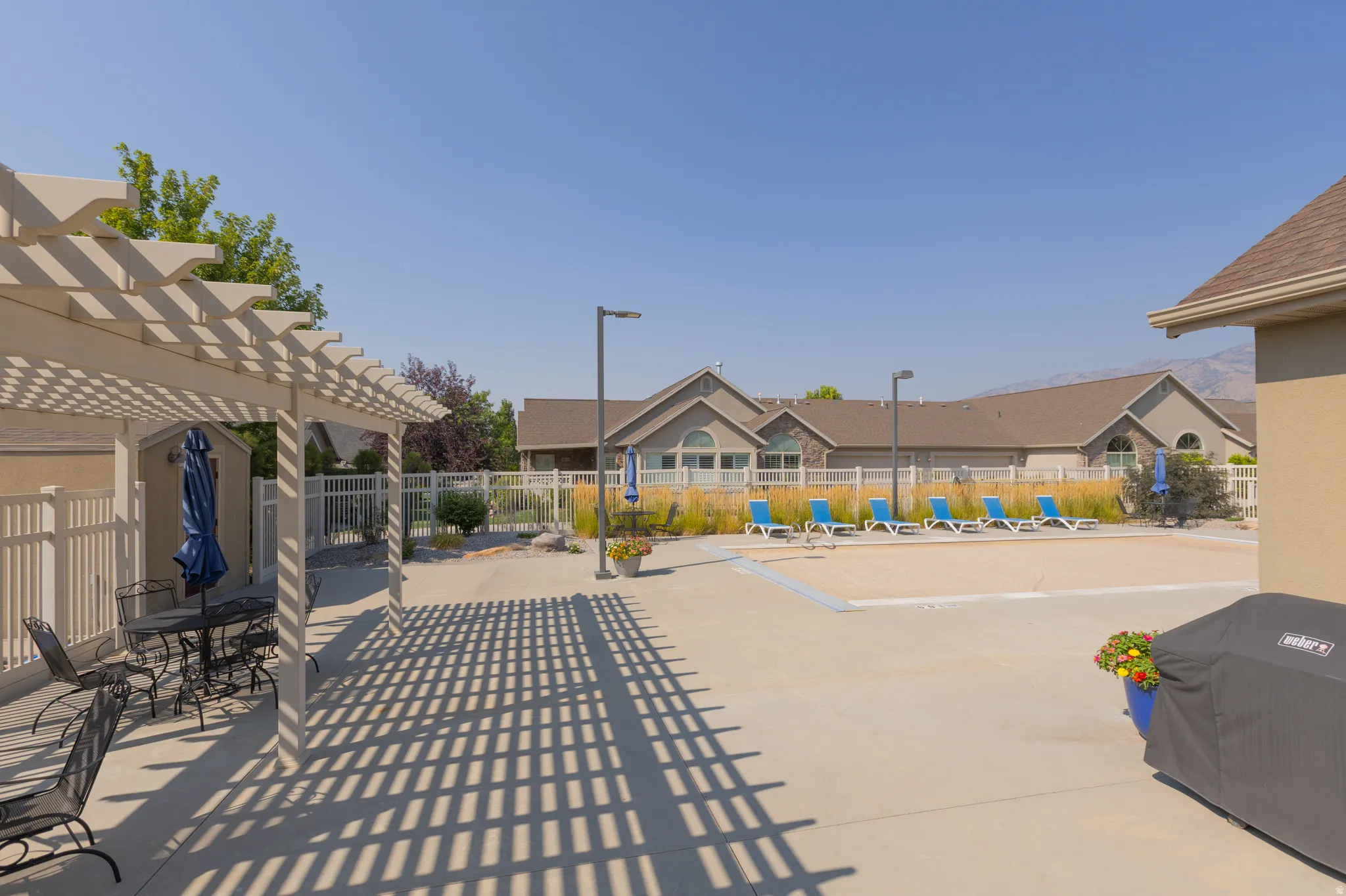Paved patio with a slatted pergola