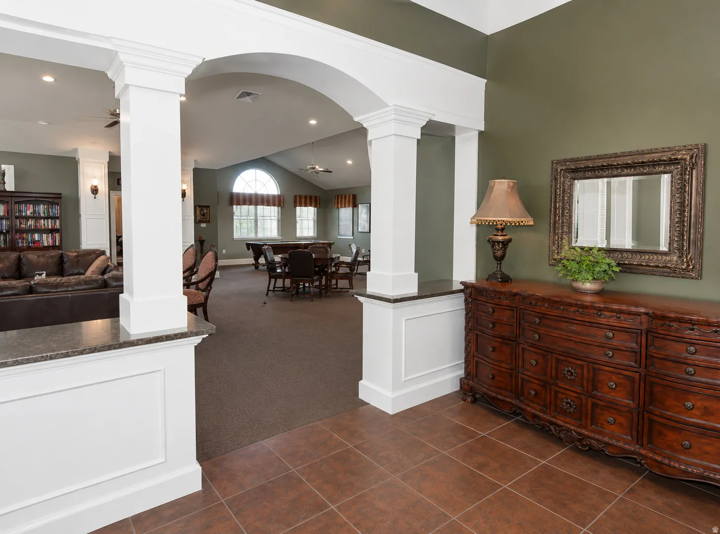 Arched entryway with substantial white columns and wainscoting
