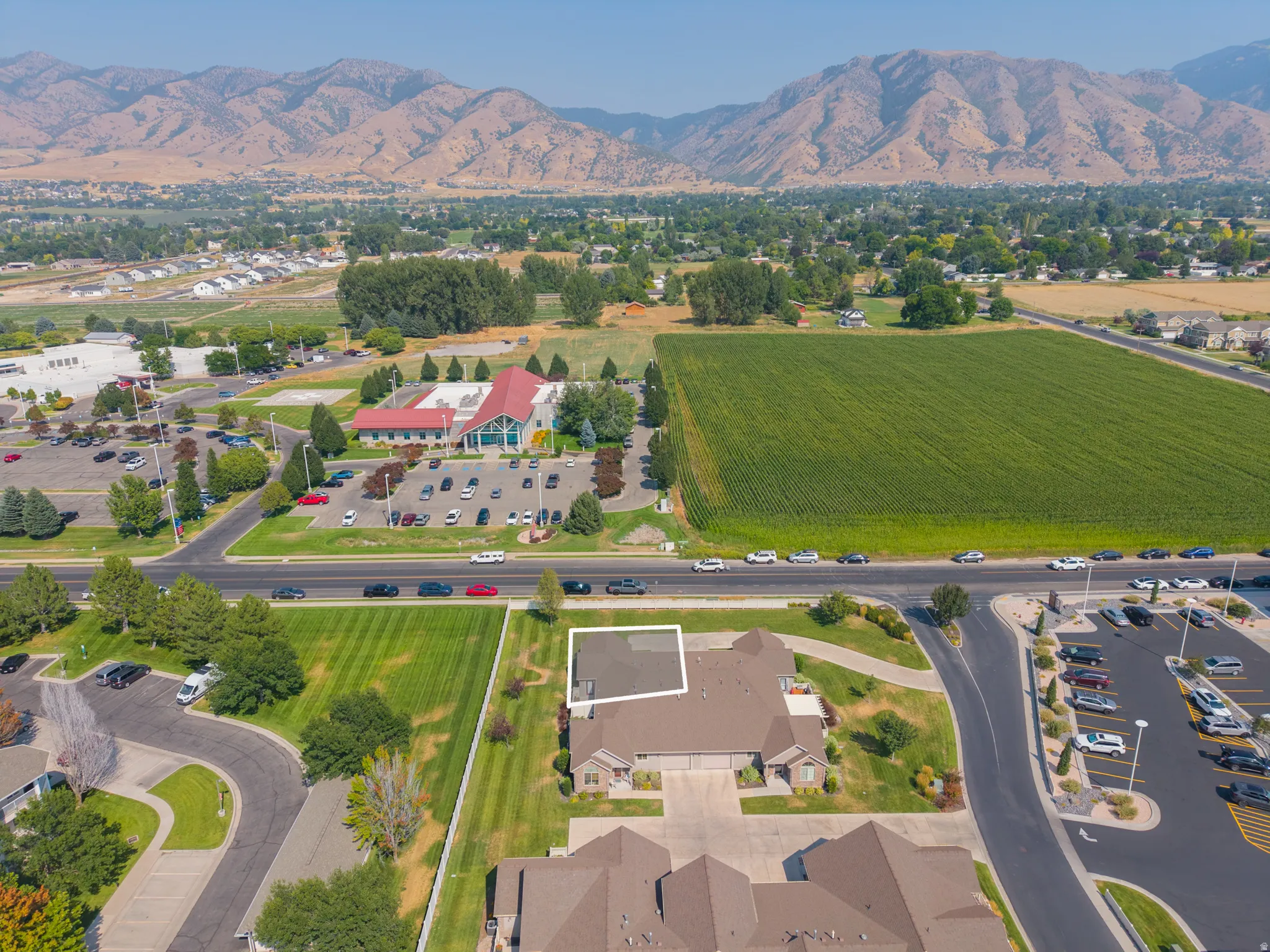 Mountain backdrop, extensive green space, paved roads, and developed parking areas