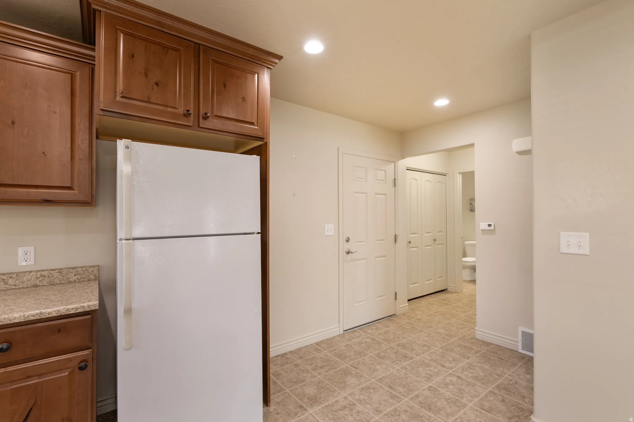 Wood-finish cabinetry paired with a light-toned countertop