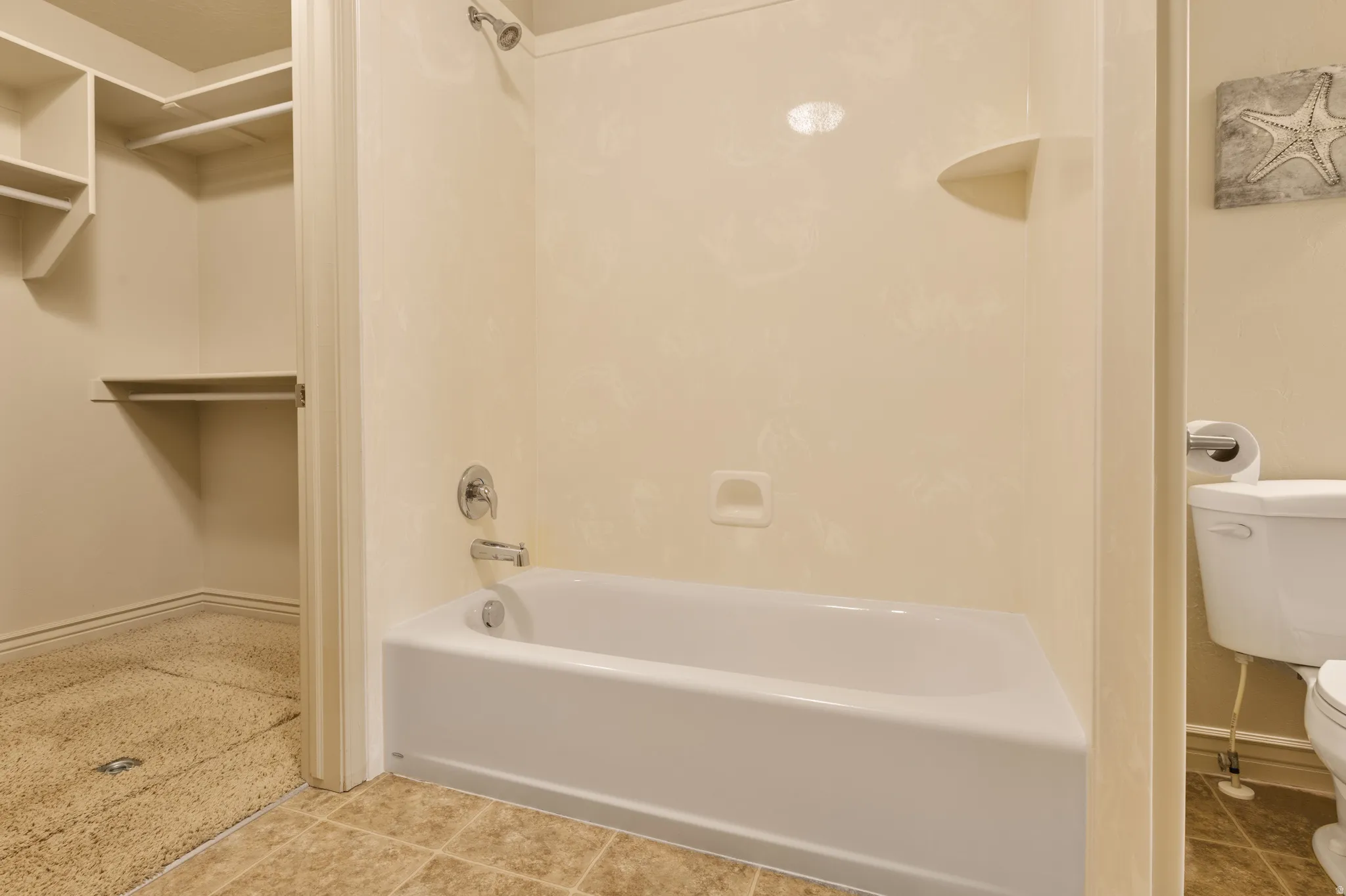 Tub/shower combination with chrome fixtures and integrated shelving