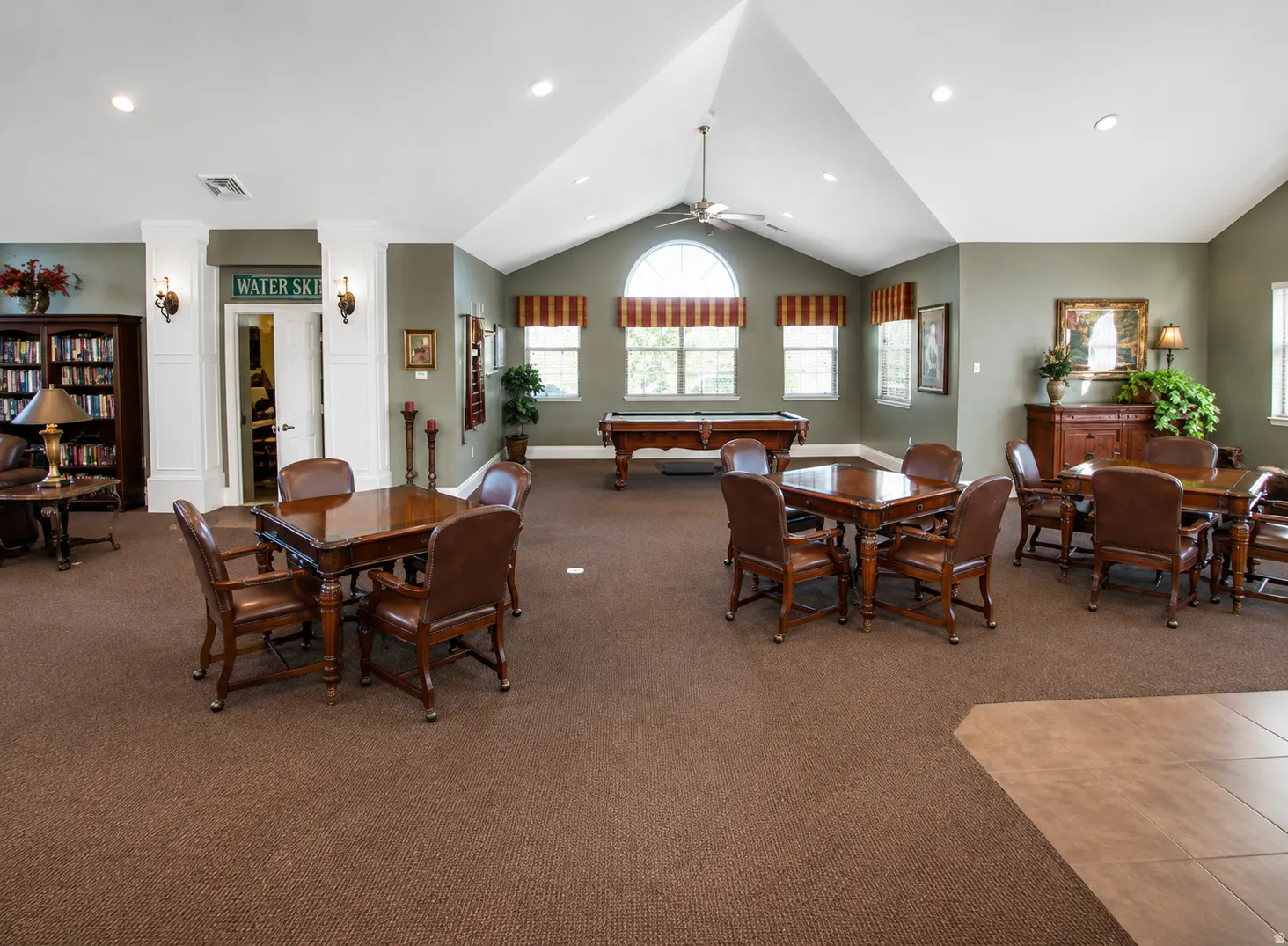 Spacious common area featuring vaulted ceilings, recessed lighting, and a ceiling fan