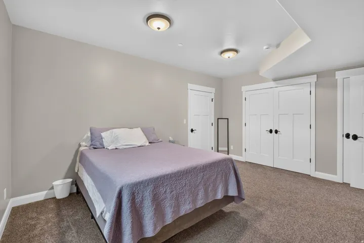 Neutral-toned walls, recessed ceiling lighting, and plush carpet flooring