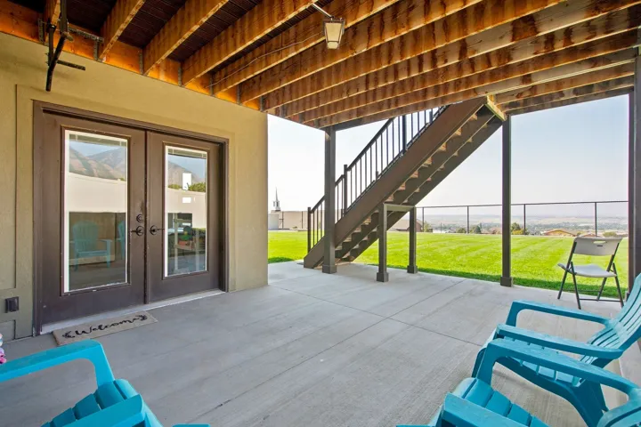 Expansive concrete patio with exposed wood joist ceiling