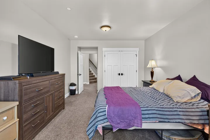 Plush carpeting, recessed lighting, and a flush-mount ceiling fixture