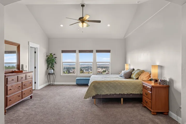 Vaulted ceiling with a ceiling fan and recessed lighting