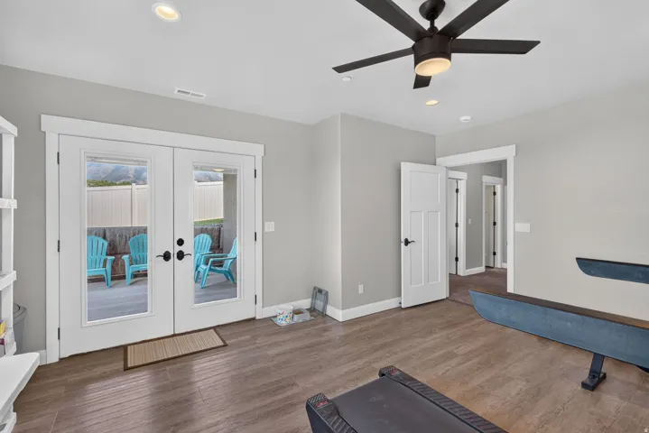 Wood-finish flooring, recessed lighting, and a ceiling fan