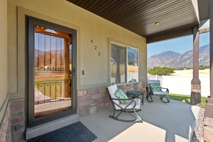 Covered concrete porch with stone veneer accents