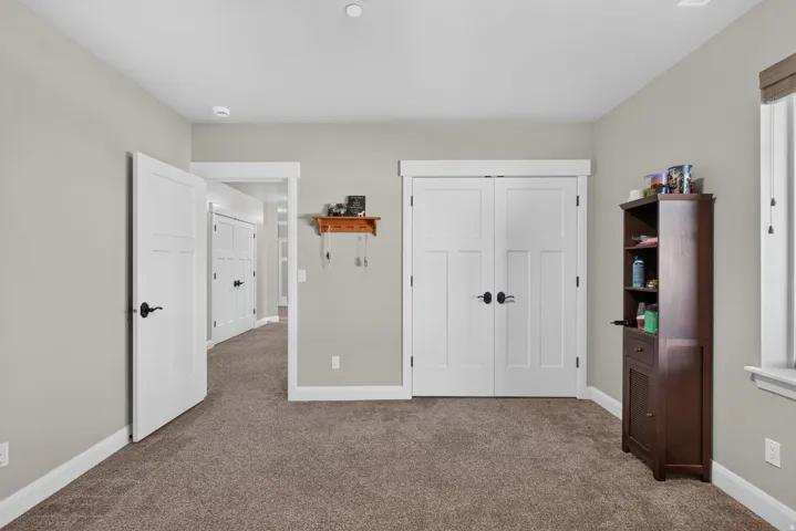 Recessed lighting, wood-finish doors, and plush carpet flooring