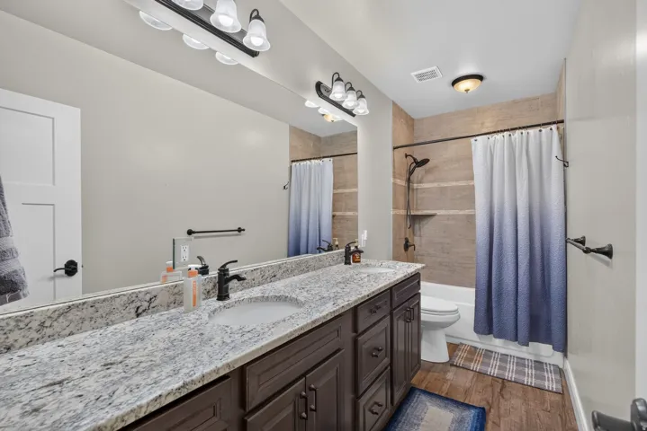 Dual vanity with stone-finish countertop and undermount sinks