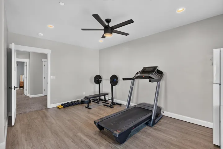 Recessed lighting, ceiling fan with light, and wood-finish flooring