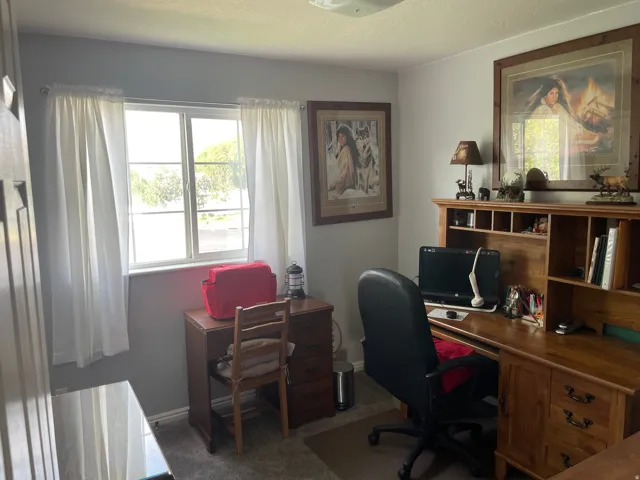 Window with outdoor scenery, light gray wall paint, and overhead lighting