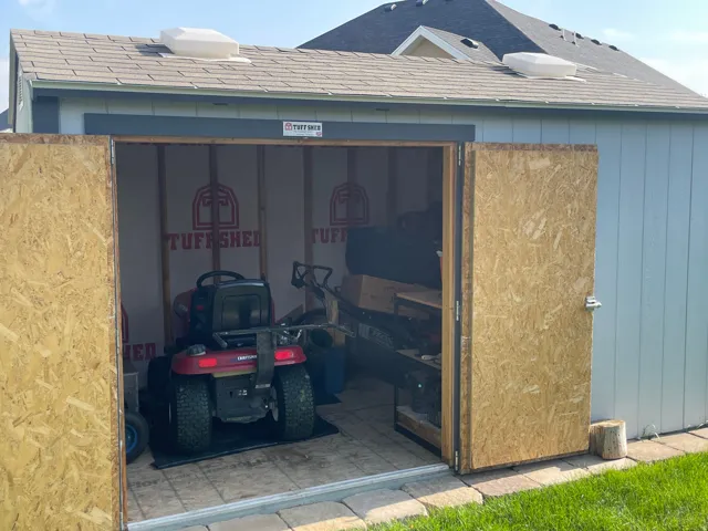 Detached shed with shingle roof and two roof vents