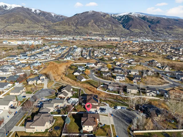 Aerial perspective showcasing a residential neighborhood with distant snow-capped mountains