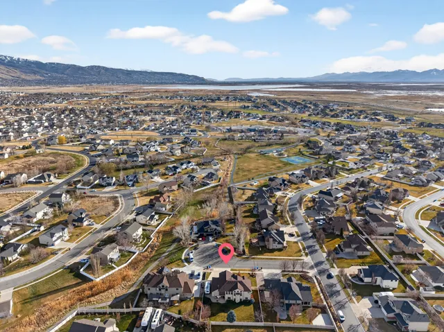 Expansive residential development with a mountain backdrop and a large body of water