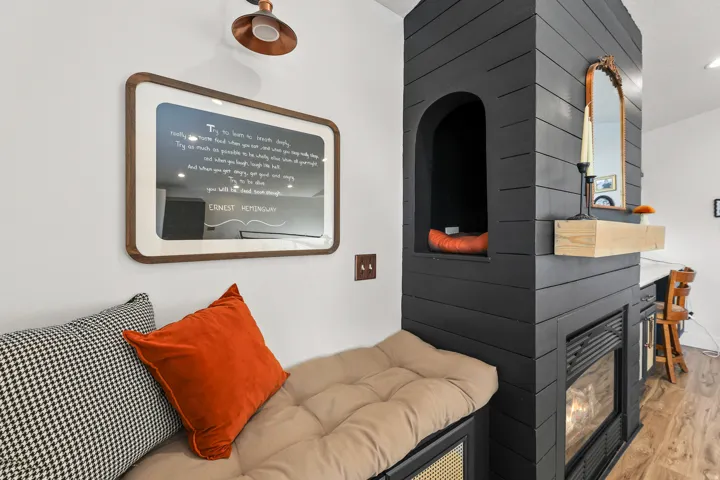 Built-in fireplace with a natural wood mantel and arched alcove