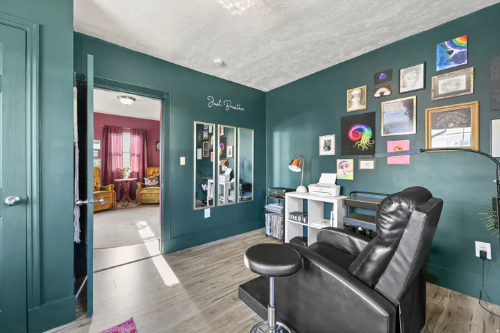 Wood-finish flooring with a deep teal wall color, providing a distinct aesthetic