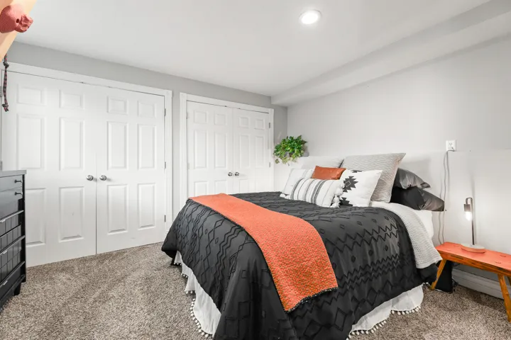 Recessed ceiling lighting, paneled doors with chrome hardware, and gray carpeting