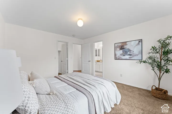 Neutral color palette, wall-to-wall carpeting, overhead flush-mount lighting, and white interior doors