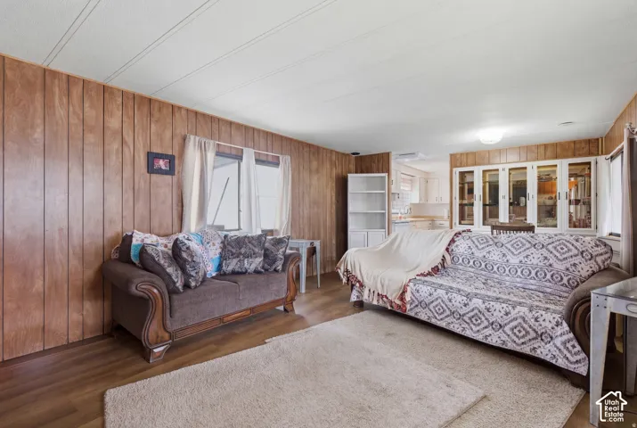 Wood-finish wall paneling, wood-finish flooring, and white ceiling panels