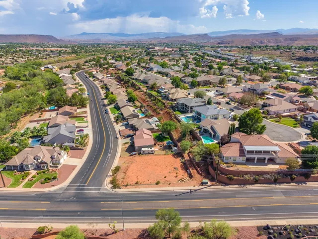 Aerial perspective showcasing a residential neighborhood with paved roadways and mature landscaping