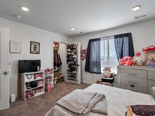 Recessed lighting, window with blinds, and neutral carpet flooring