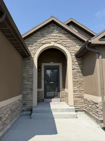 Stone veneer facade with an arched entryway